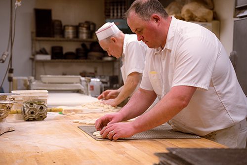 Raphael's Bakery employees creating baked goods in the kitchen