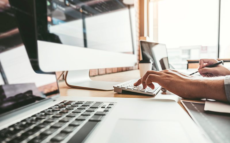 Person typing at a computer