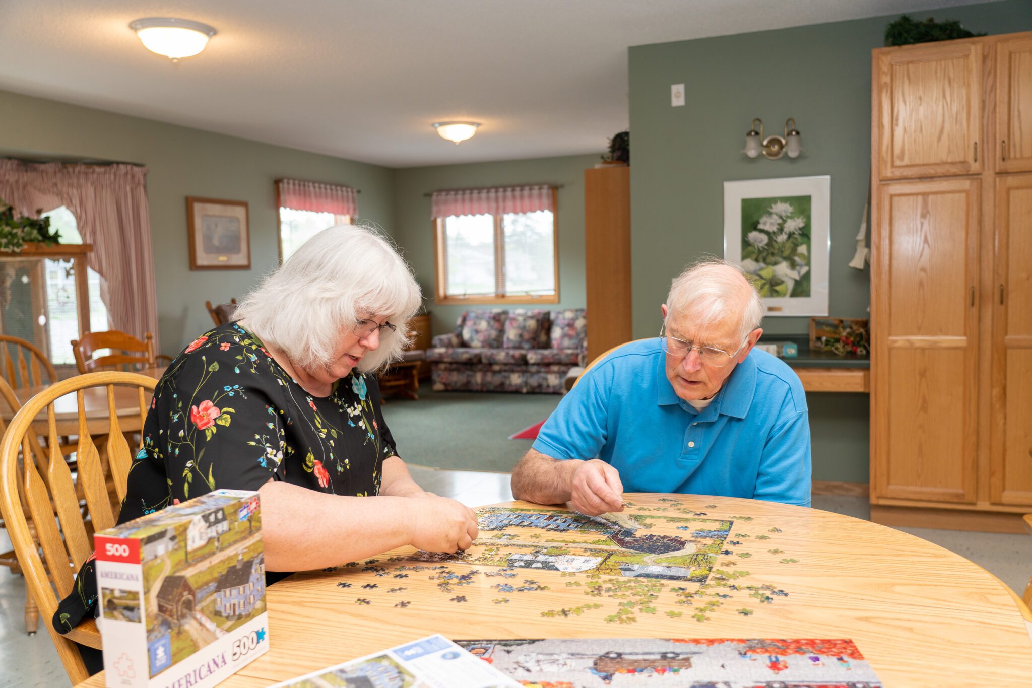 Two seniors putting together a puzzle in Eldercare of Bemidji