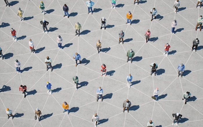 People standing with lines on the ground connecting them into a community