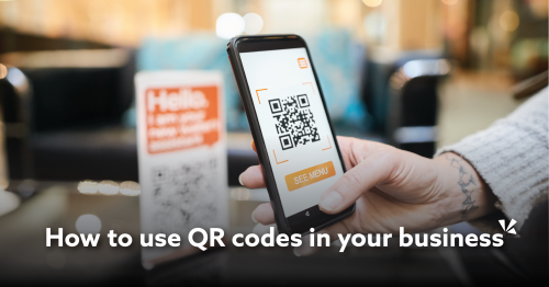 Picture of a person scanning a QR code with their smartphone "How to use QR codes in your business"