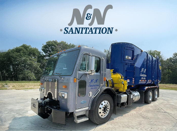 Side load garbage truck with N&N Sanitation logo