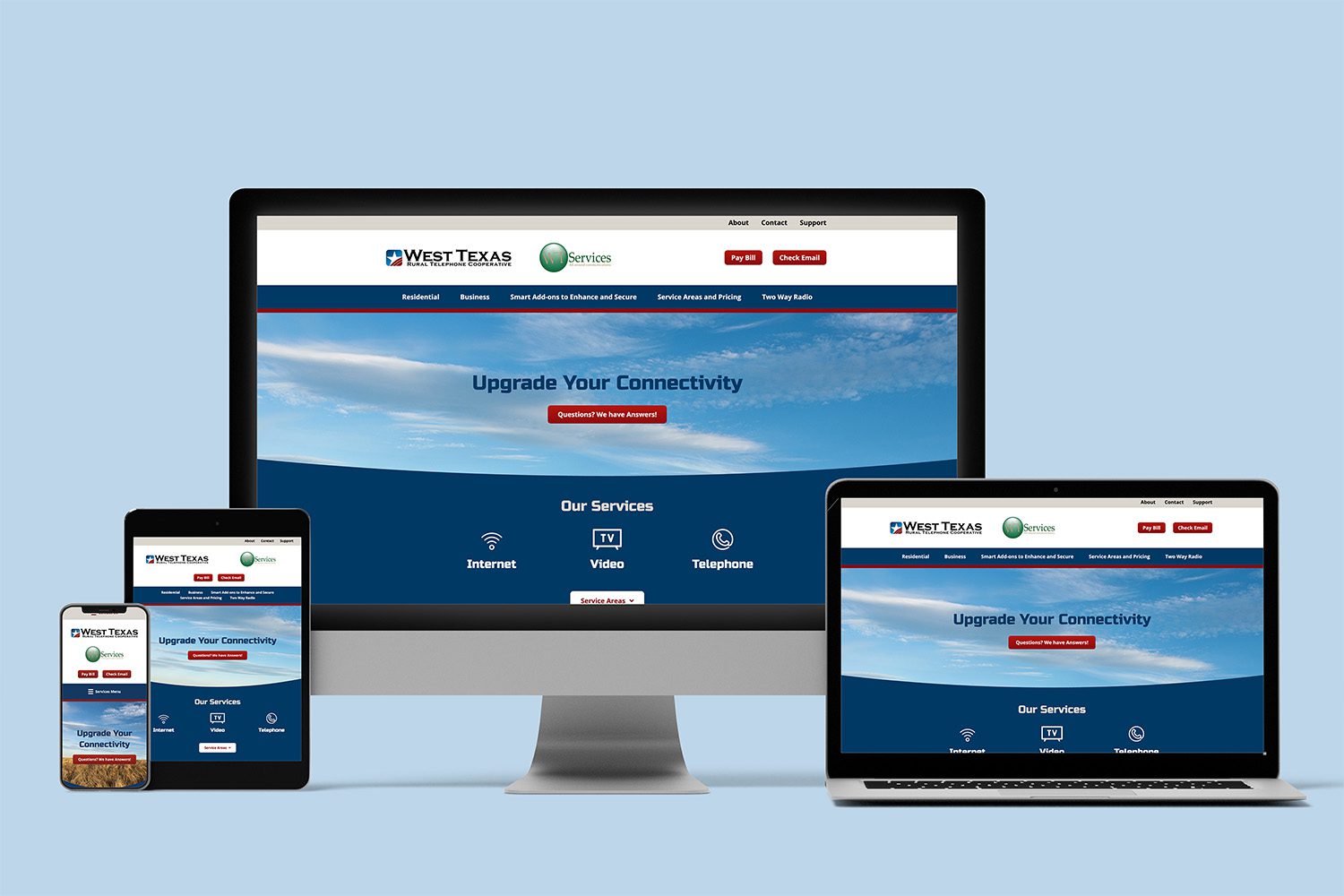 Responsive display of the redesigned West Texas Rural Telephone Cooperative website shown on a desktop computer, laptop, tablet, and smartphone, all featuring the homepage with a blue sky banner and service options.
